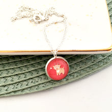 Girls red reindeer pendant necklace on a silver link chain